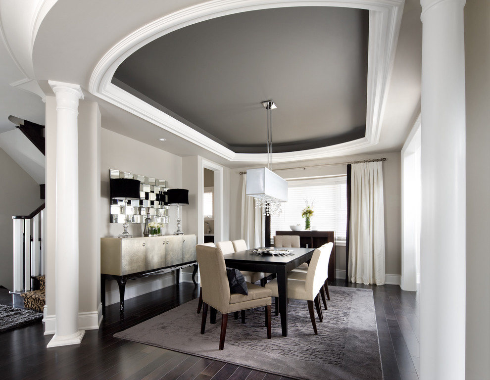 Inspiration for a transitional dark wood floor and black floor dining room remodel in Toronto with gray walls