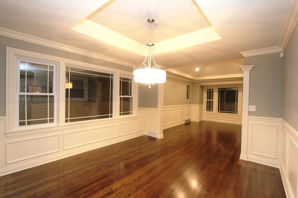 Mid-sized transitional dark wood floor dining room photo in Chicago with gray walls