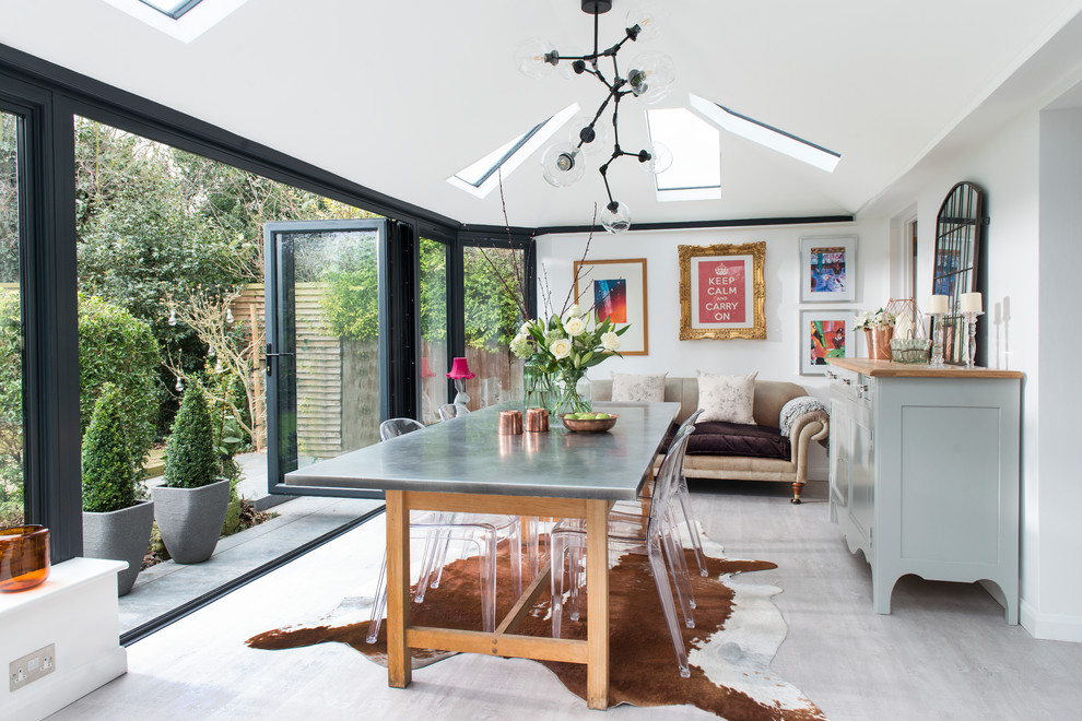 Inspiration for a medium sized eclectic dining room in Hertfordshire with white walls and grey floors.