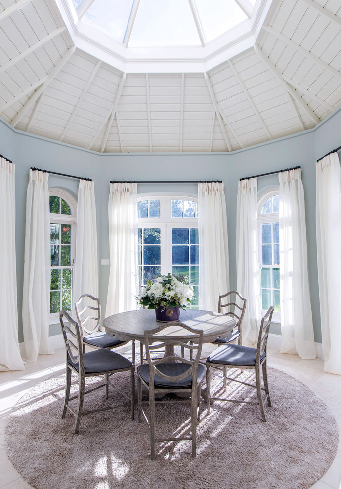 Nautical dining room in Channel Islands with blue walls.