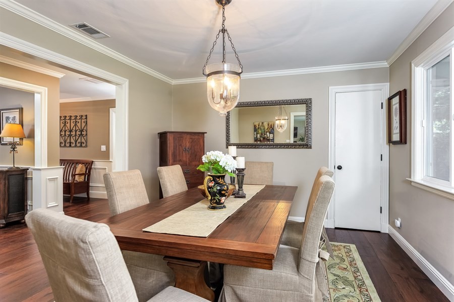 Example of a mid-sized classic medium tone wood floor enclosed dining room design in San Francisco with gray walls