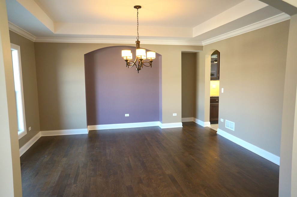 Inspiration for a large traditional dining room in Chicago with beige walls and dark hardwood flooring.
