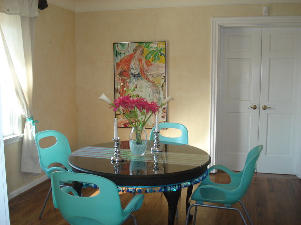 Bohemian dining room in St Louis with beige walls and dark hardwood flooring.
