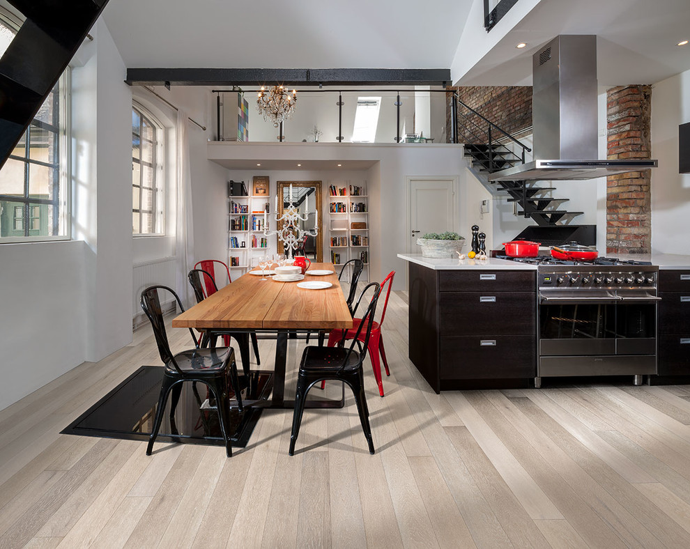 Photo of a medium sized industrial kitchen/dining room in Chicago with white walls and light hardwood flooring.