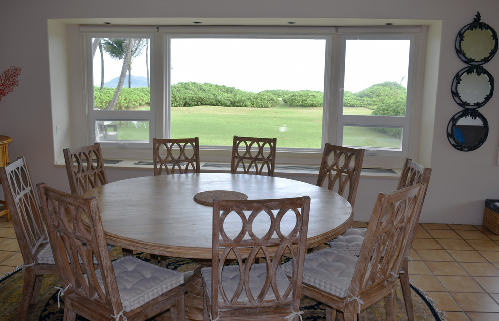 Example of a mid-sized island style terra-cotta tile kitchen/dining room combo design in Hawaii with white walls and no fireplace