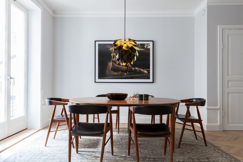 Scandi dining room in Other with grey walls, light hardwood flooring and beige floors.