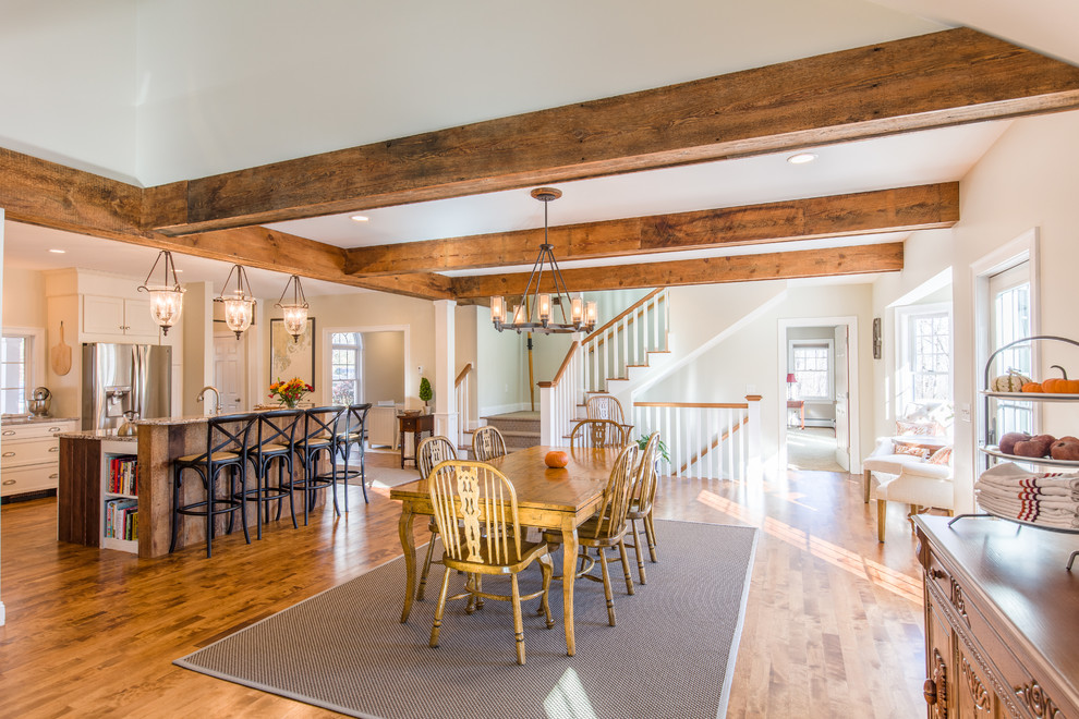 Medium sized classic kitchen/dining room in Portland Maine with white walls, medium hardwood flooring, a standard fireplace and a brick fireplace surround.