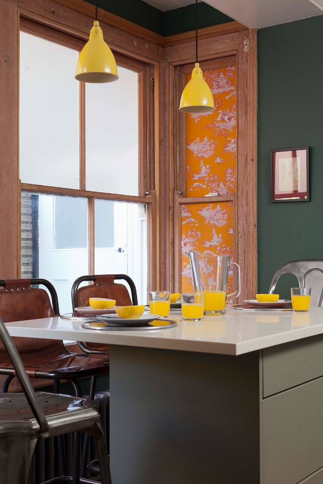 Ispirazione per una sala da pranzo bohémian con pareti verdi, pavimento in laminato e pavimento marrone