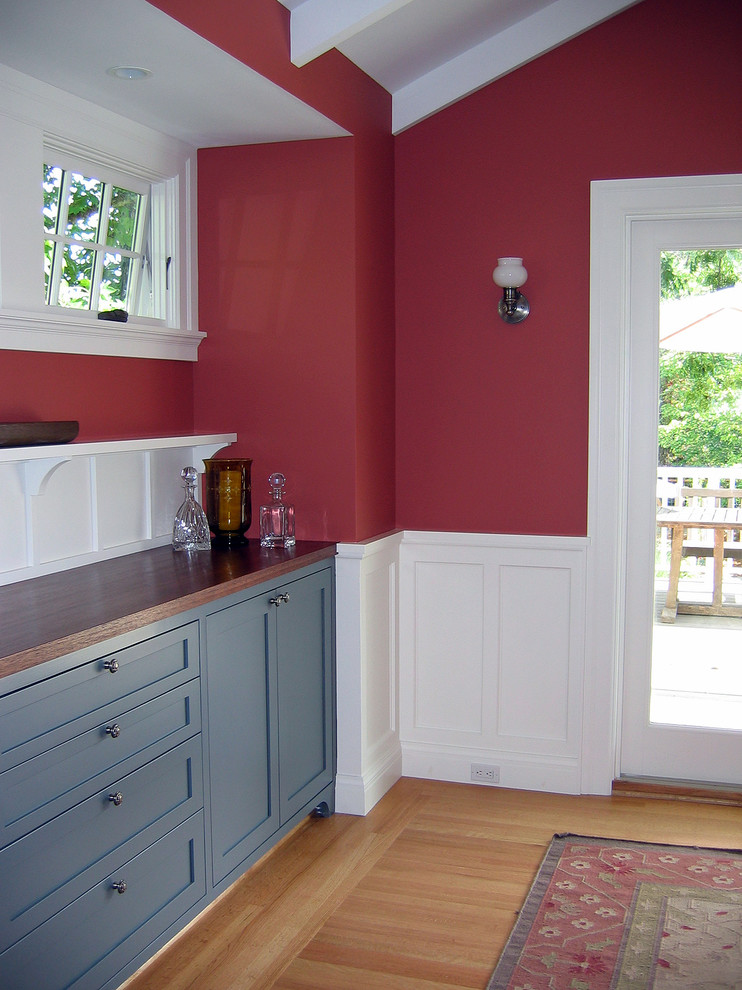 Example of a mid-sized transitional light wood floor and brown floor kitchen/dining room combo design in San Francisco with red walls and no fireplace