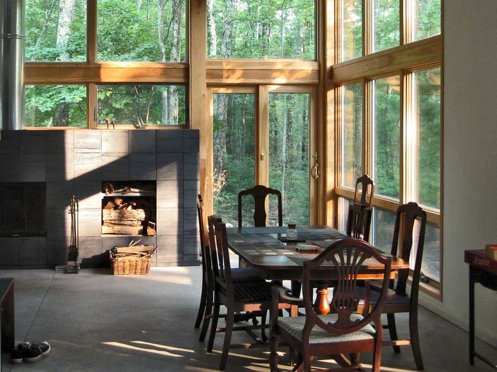 Exemple d'une salle à manger éclectique avec un mur gris et une cheminée standard.