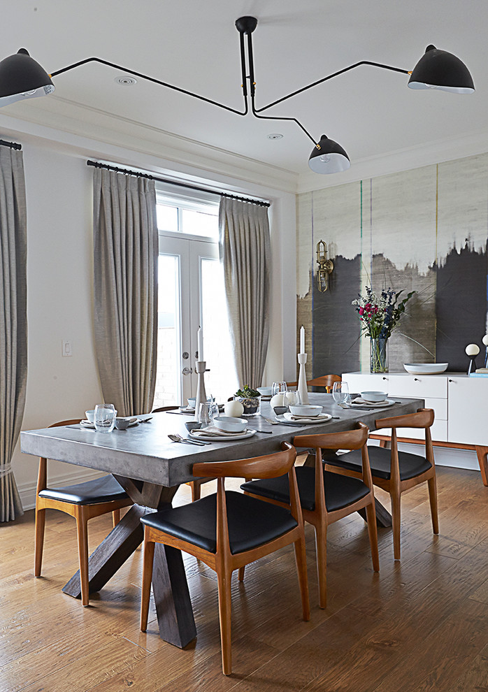 Idee per una sala da pranzo contemporanea con pareti bianche, pavimento in legno massello medio e nessun camino