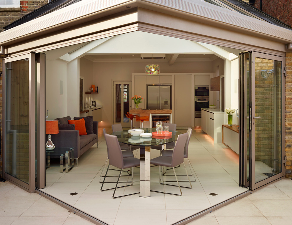 Photo of a contemporary dining room in London with feature lighting.