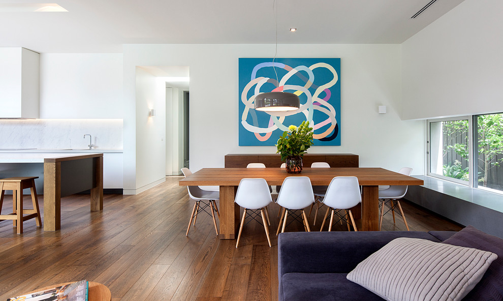 Offenes Modernes Esszimmer mit weißer Wandfarbe und dunklem Holzboden in Melbourne