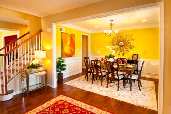 Medium sized traditional enclosed dining room in Other with yellow walls and medium hardwood flooring.