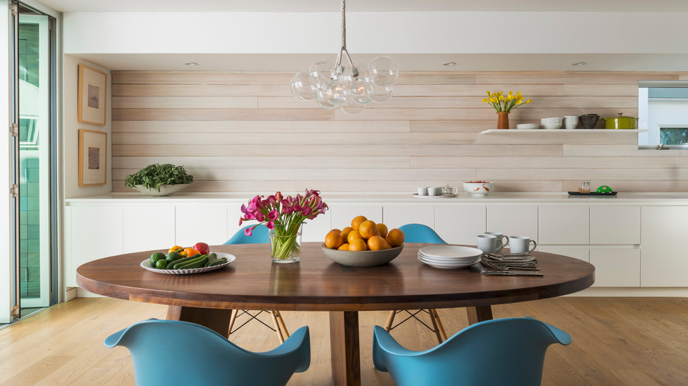 Photo of a contemporary kitchen/dining room in Los Angeles with white walls and medium hardwood flooring.