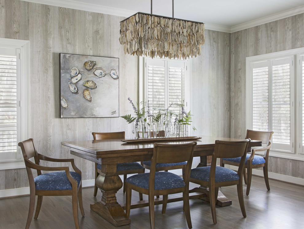 Design ideas for a beach style dining room in Charleston with brown walls, dark hardwood flooring, no fireplace and wood walls.