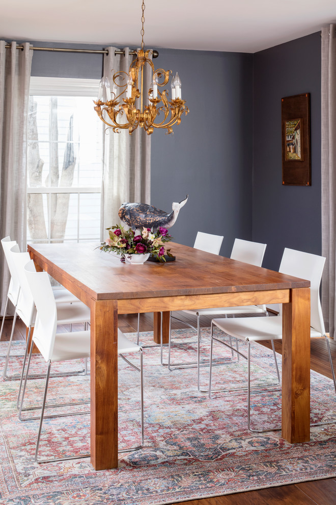 Inspiration for a mid-sized transitional medium tone wood floor and brown floor dining room remodel in Richmond with black walls