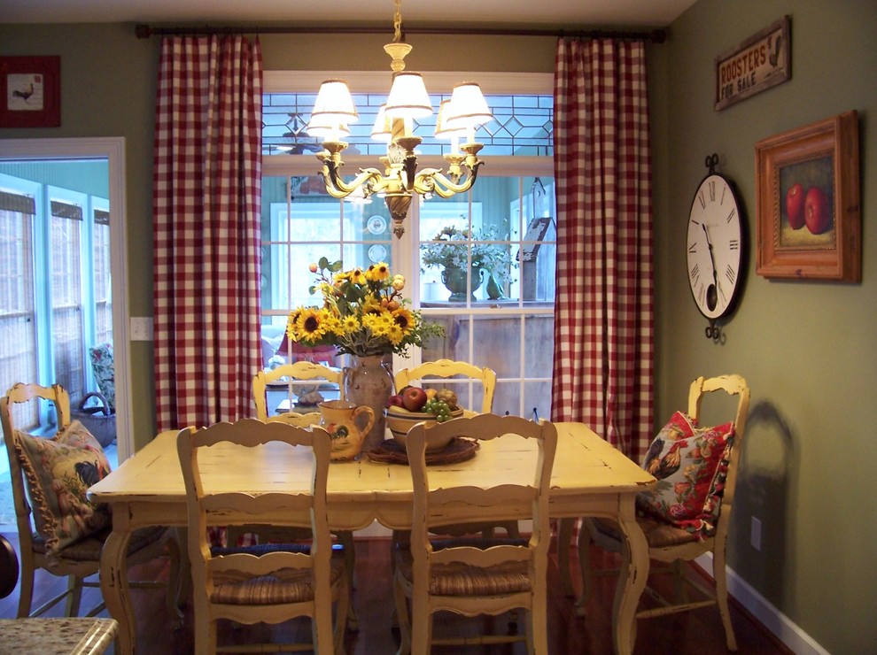 Inspiration for a country dining room in Atlanta with green walls and dark hardwood flooring.