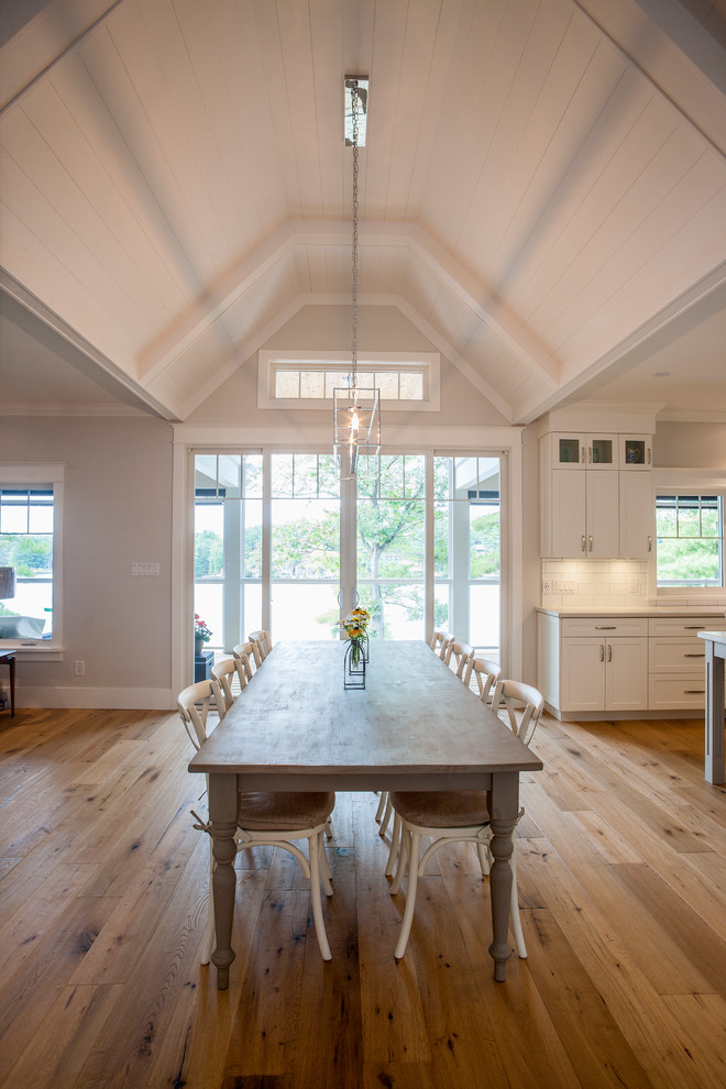 Photo of a large farmhouse open plan dining room in Toronto with grey walls, light hardwood flooring, no fireplace and brown floors.