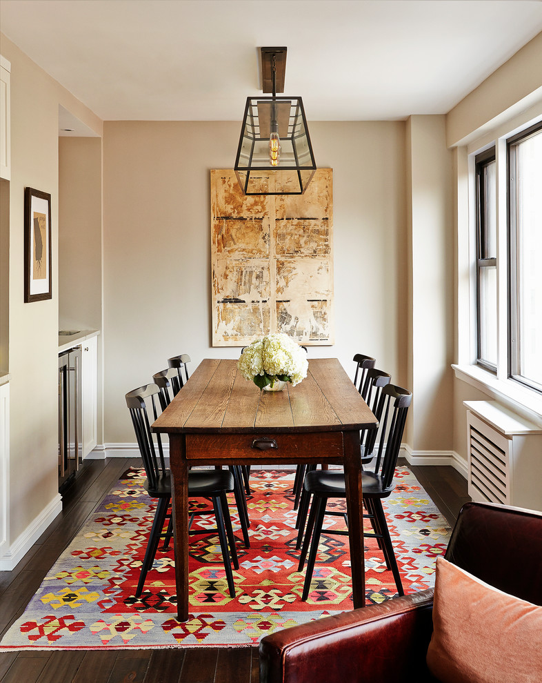 Traditional open plan dining room in New York with beige walls and dark hardwood flooring.
