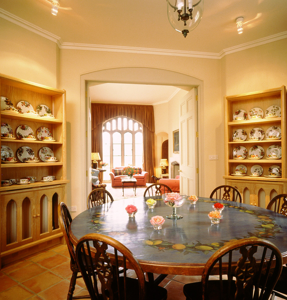 Example of a classic terra-cotta tile dining room design in Other