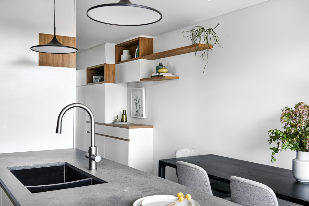 Photo of a medium sized scandi kitchen/dining room in Sydney with white walls, dark hardwood flooring and brown floors.