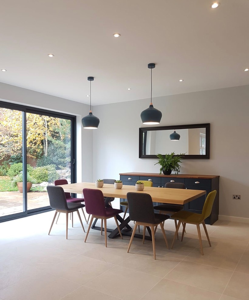 This is an example of a large scandi kitchen/dining room in Hertfordshire with grey walls, porcelain flooring and grey floors.