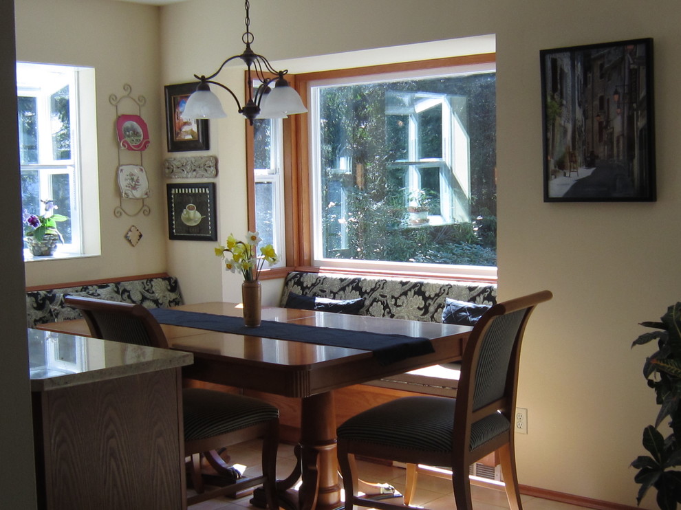 Photo of a small mediterranean kitchen/dining room in Vancouver with yellow walls and porcelain flooring.