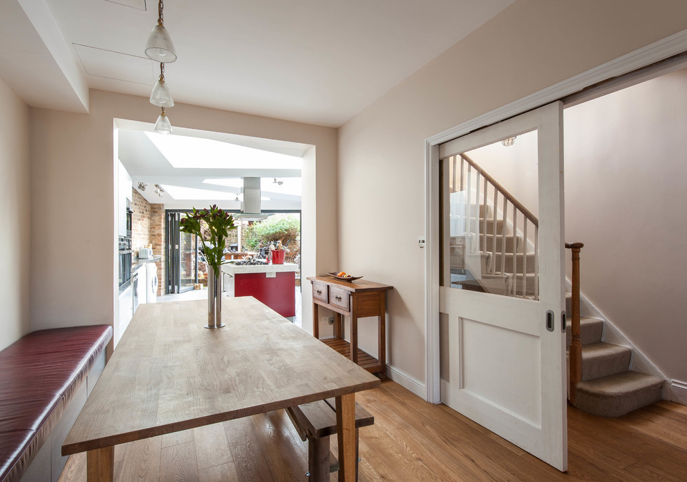 Inspiration for a medium sized modern kitchen/dining room in London with medium hardwood flooring.