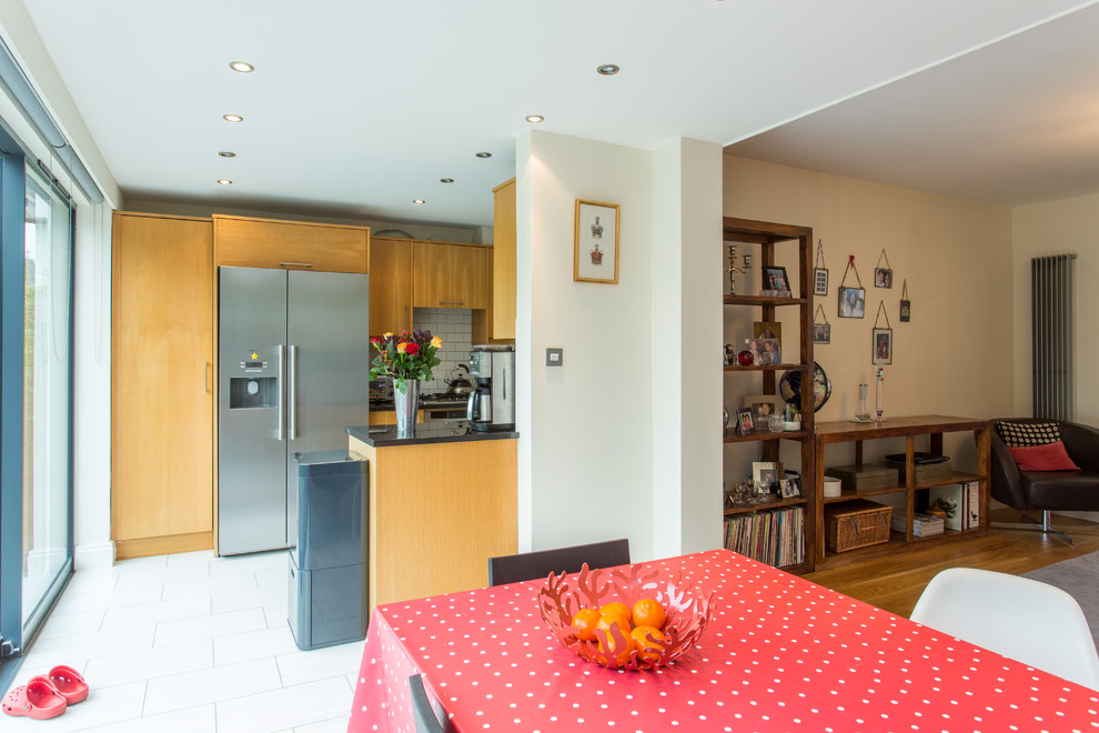 This is an example of a medium sized contemporary enclosed dining room in Other with white walls and ceramic flooring.