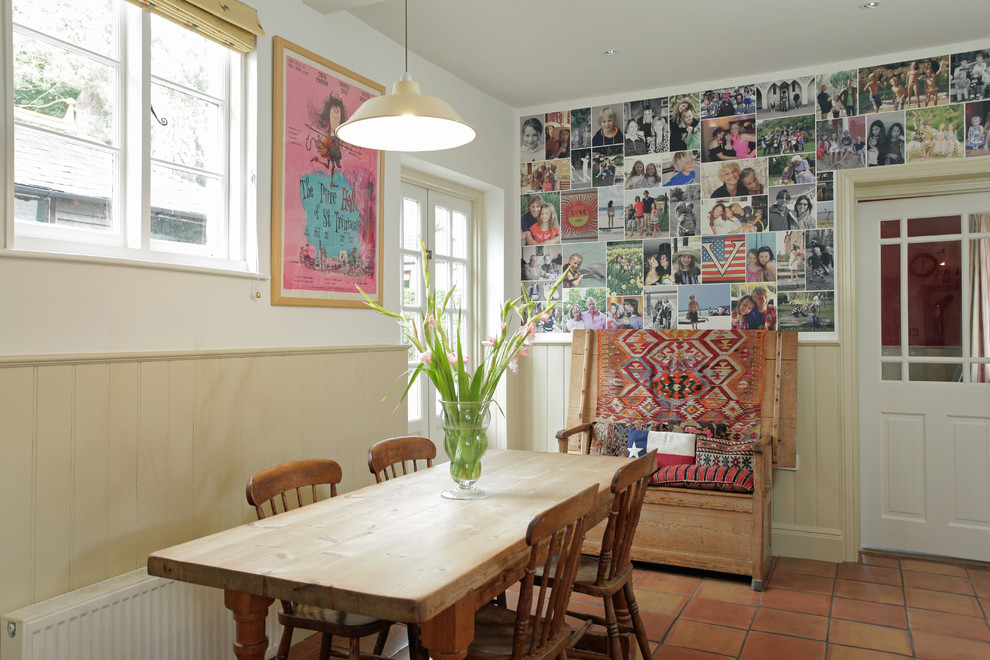 Eclectic dining room in London with white walls.