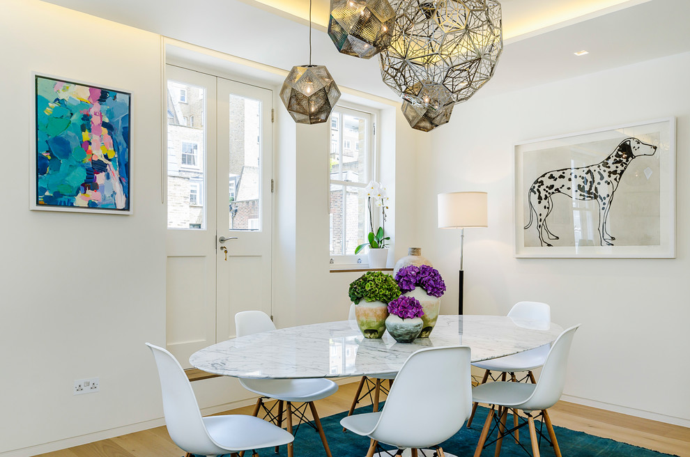 Inspiration for a medium sized contemporary dining room in London with white walls, light hardwood flooring and beige floors.