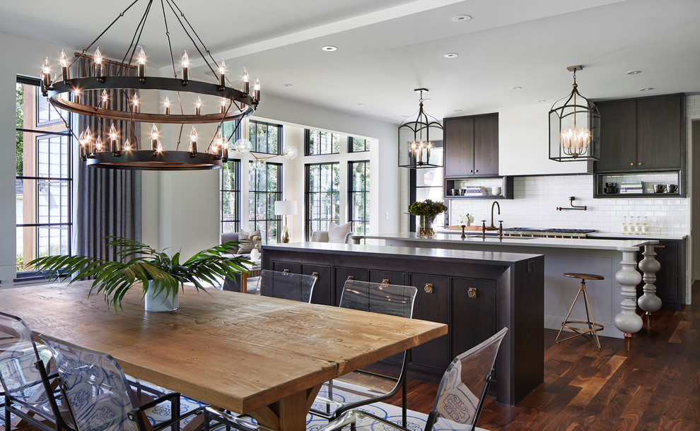 This is an example of a large traditional open plan dining room in Minneapolis with dark hardwood flooring, white walls, no fireplace, brown floors and feature lighting.