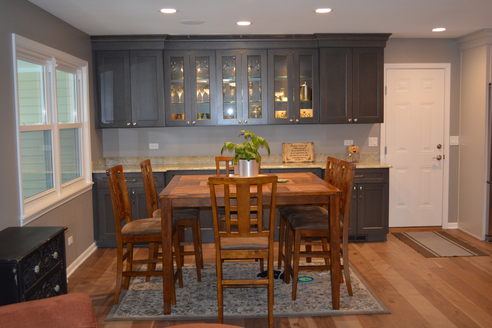 Mid-sized trendy medium tone wood floor kitchen/dining room combo photo in Chicago with gray walls and no fireplace