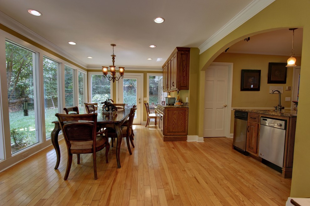 Design ideas for a large traditional open plan dining room in Atlanta with green walls and light hardwood flooring.