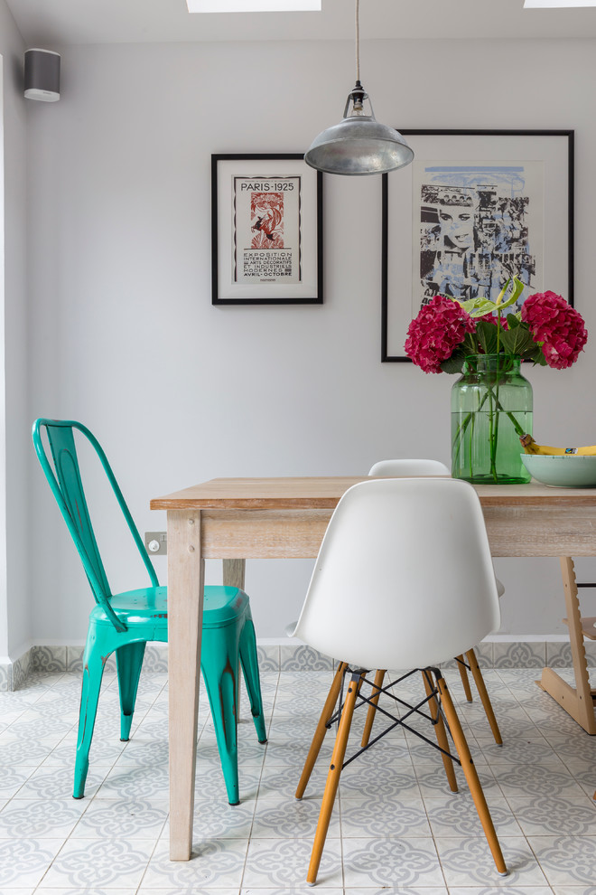 This is an example of a scandi dining room in London with grey walls.