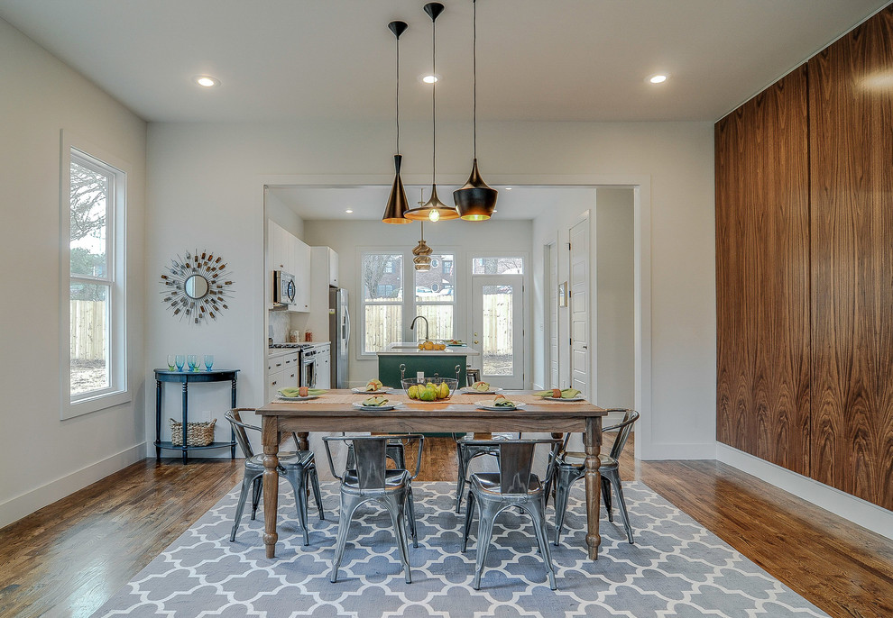 Inspiration for an eclectic medium tone wood floor kitchen/dining room combo remodel in Nashville with white walls