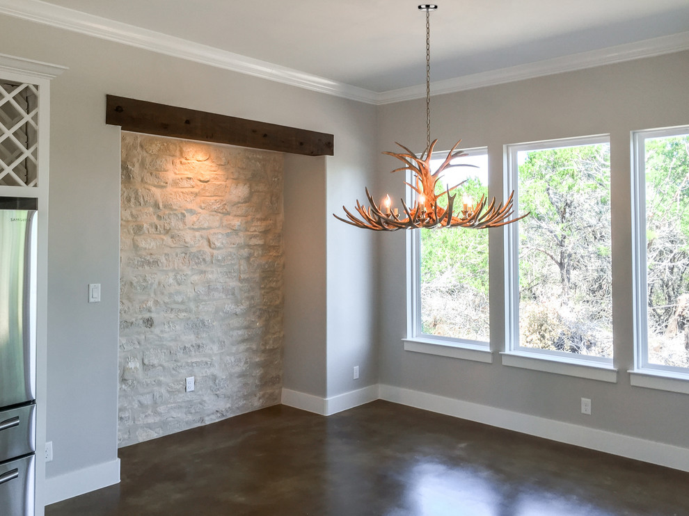 Design ideas for a dining room in Austin with grey walls and concrete flooring.