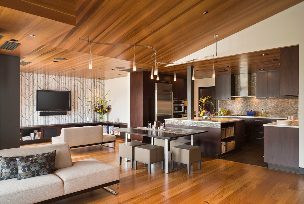 This is an example of a contemporary open plan dining room in Portland with white walls and medium hardwood flooring.