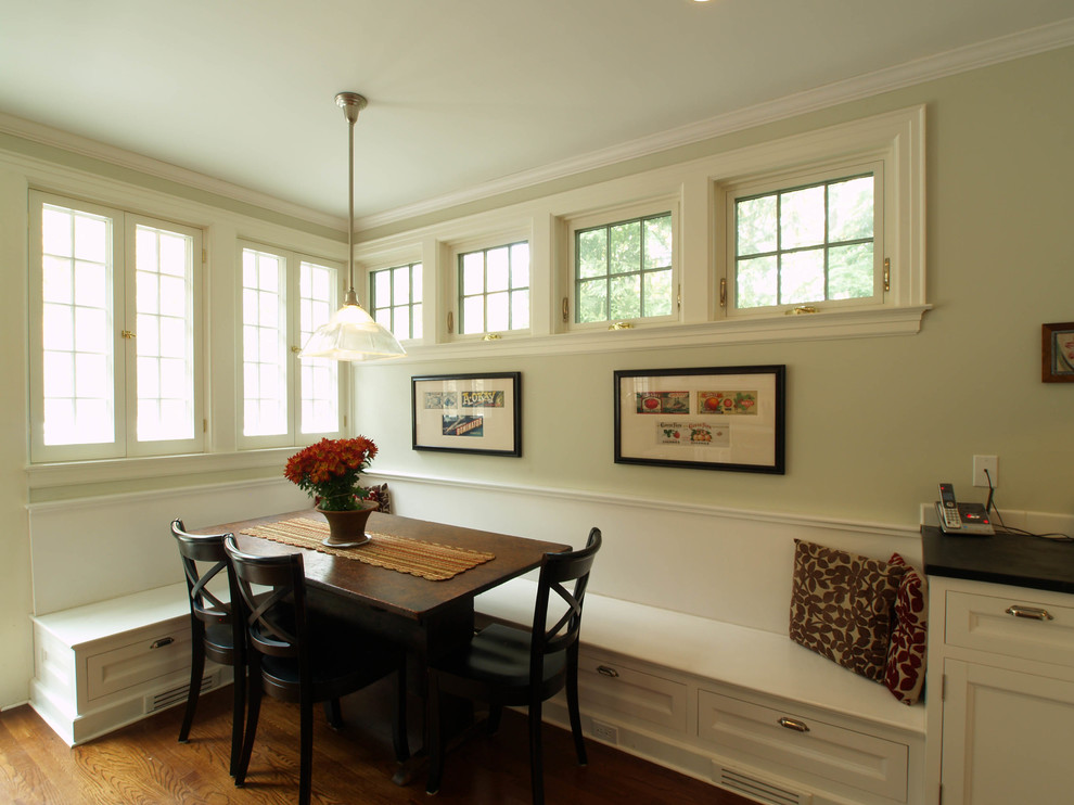 Photo of a large traditional kitchen/dining room in New York with dark hardwood flooring, beige walls, no fireplace and brown floors.