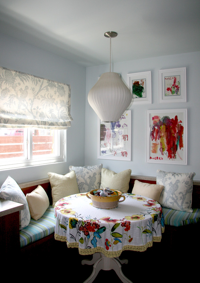 Eclectic dining room photo in Los Angeles with blue walls