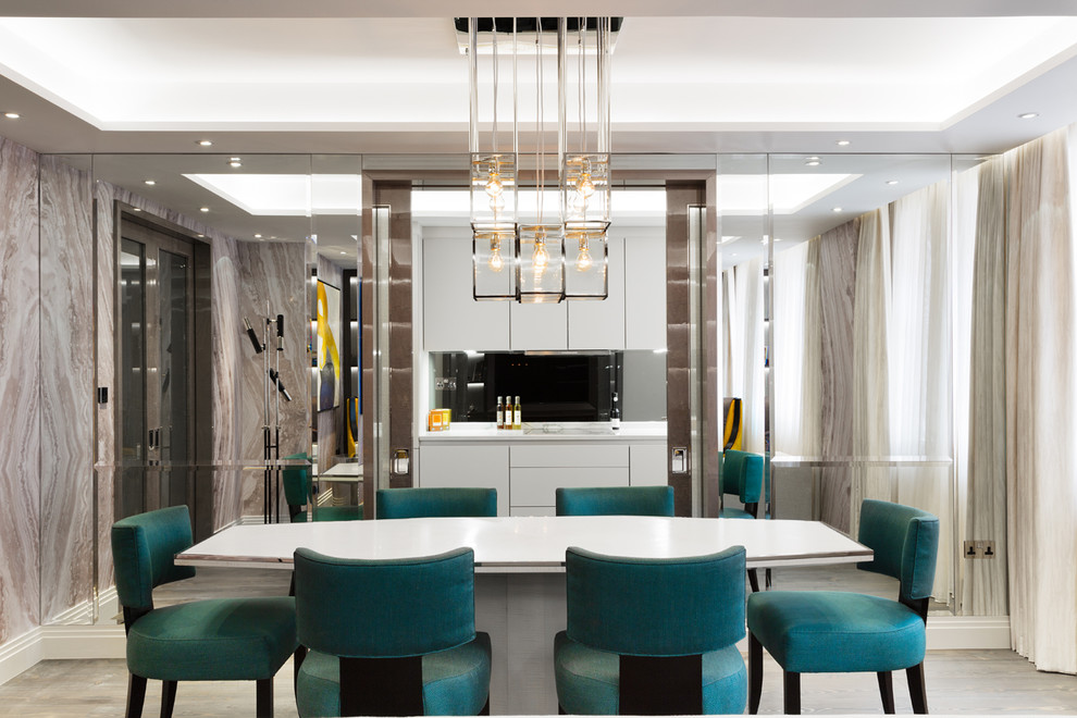 Inspiration for a contemporary enclosed dining room in London with metallic walls, no fireplace and grey floors.