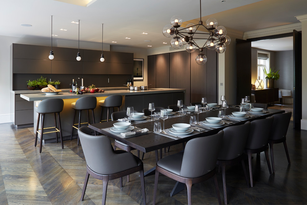 Contemporary kitchen/dining room in London with grey walls and dark hardwood flooring.