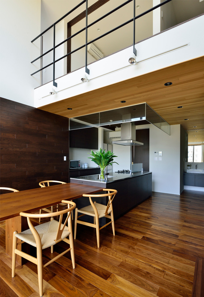 Inspiration for a modern open plan dining room in Nagoya with white walls, medium hardwood flooring and brown floors.