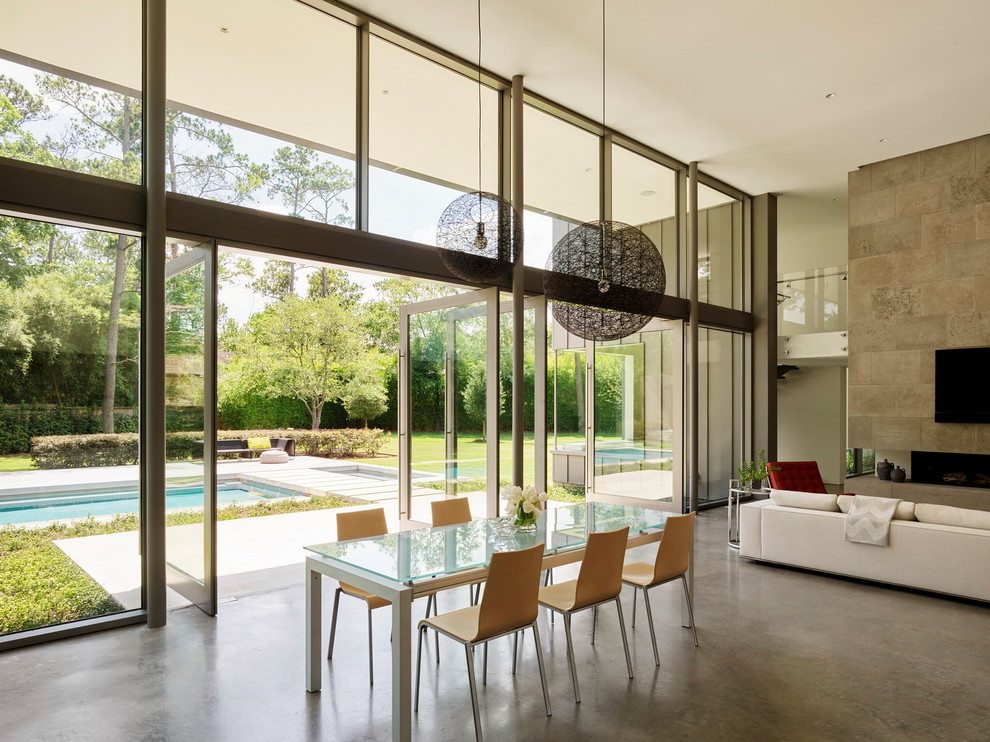 Идея дизайна: гостиная-столовая в стиле модернизм с белыми стенами, бетонным полом и серым полом