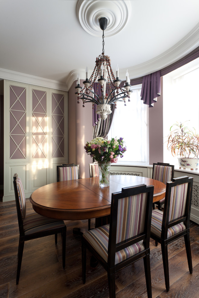 Foto di una sala da pranzo aperta verso il soggiorno tradizionale di medie dimensioni con pareti viola, parquet scuro e nessun camino