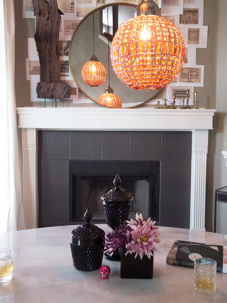 Inspiration pour une grande salle à manger ouverte sur le salon minimaliste avec un mur gris, un sol en bois brun, une cheminée d'angle et un manteau de cheminée en carrelage.