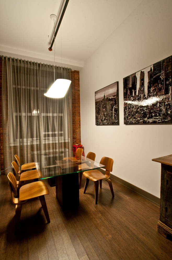 This is an example of a bohemian dining room in Montreal with white walls and dark hardwood flooring.