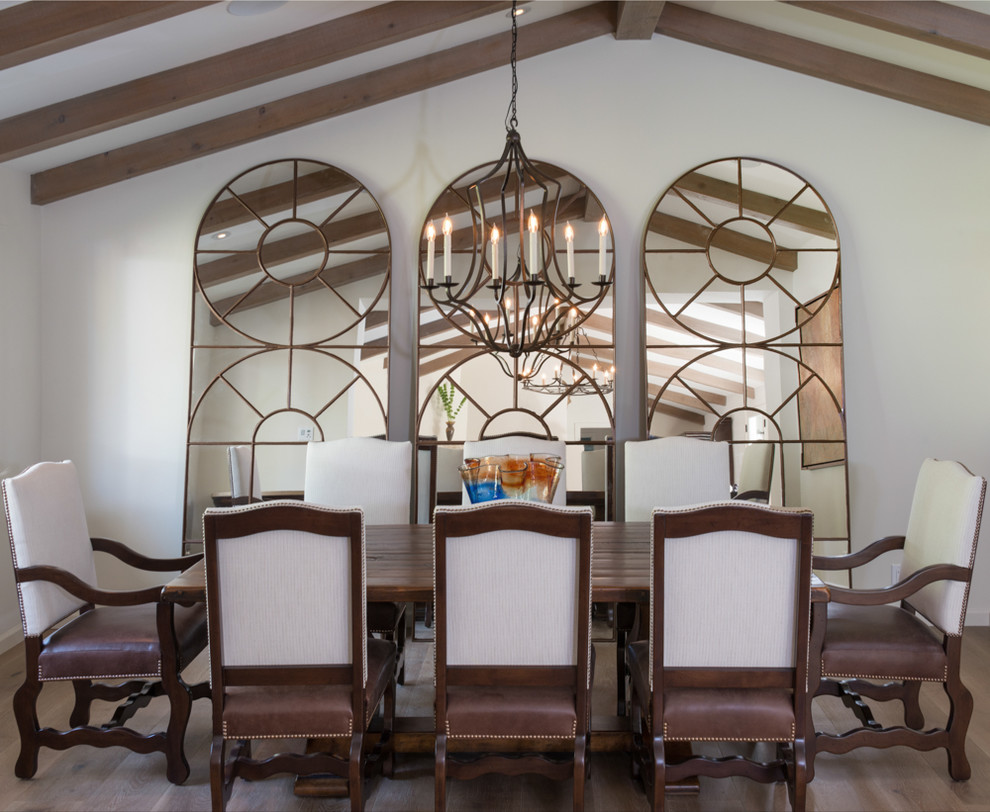 Tuscan dark wood floor dining room photo in Los Angeles with white walls