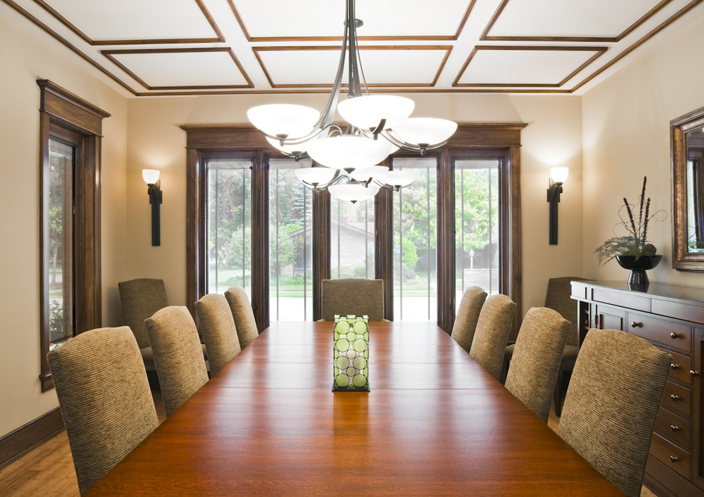 Example of a classic medium tone wood floor enclosed dining room design in Chicago with beige walls